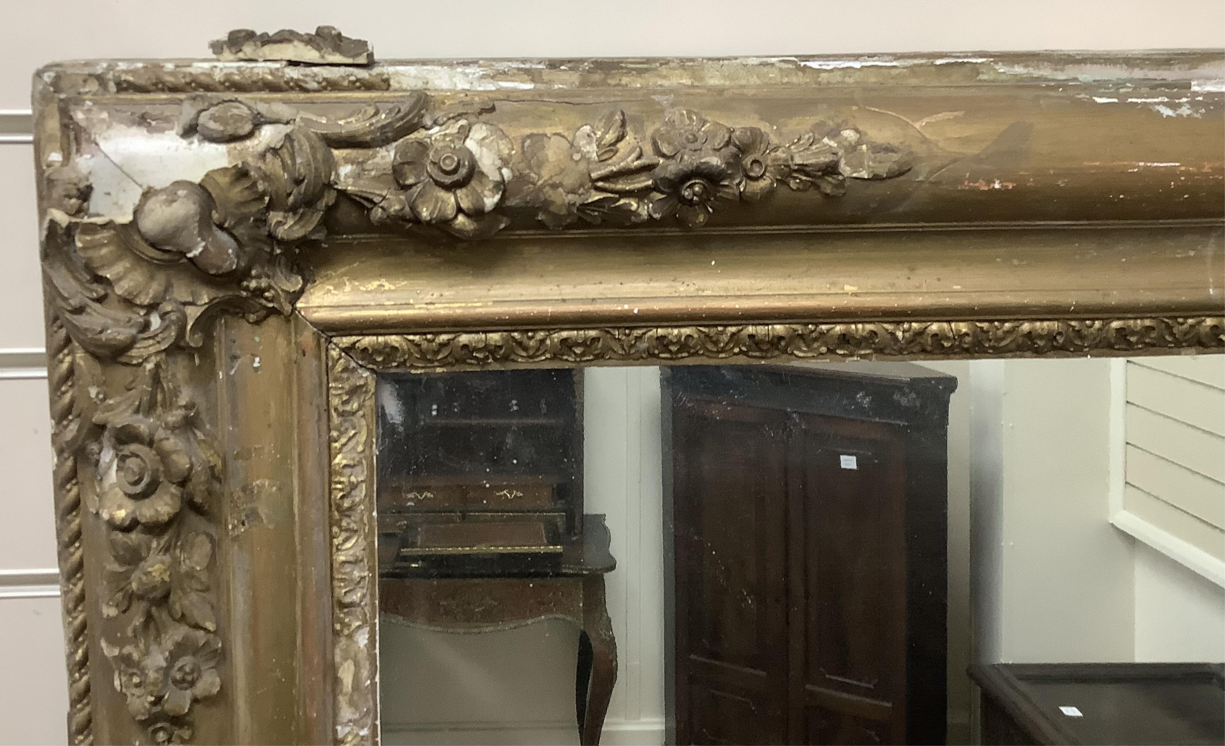 A large Victorian rectangular giltwood and composition overmantel mirror, width 137cm, height 178cm. Condition poor to fair